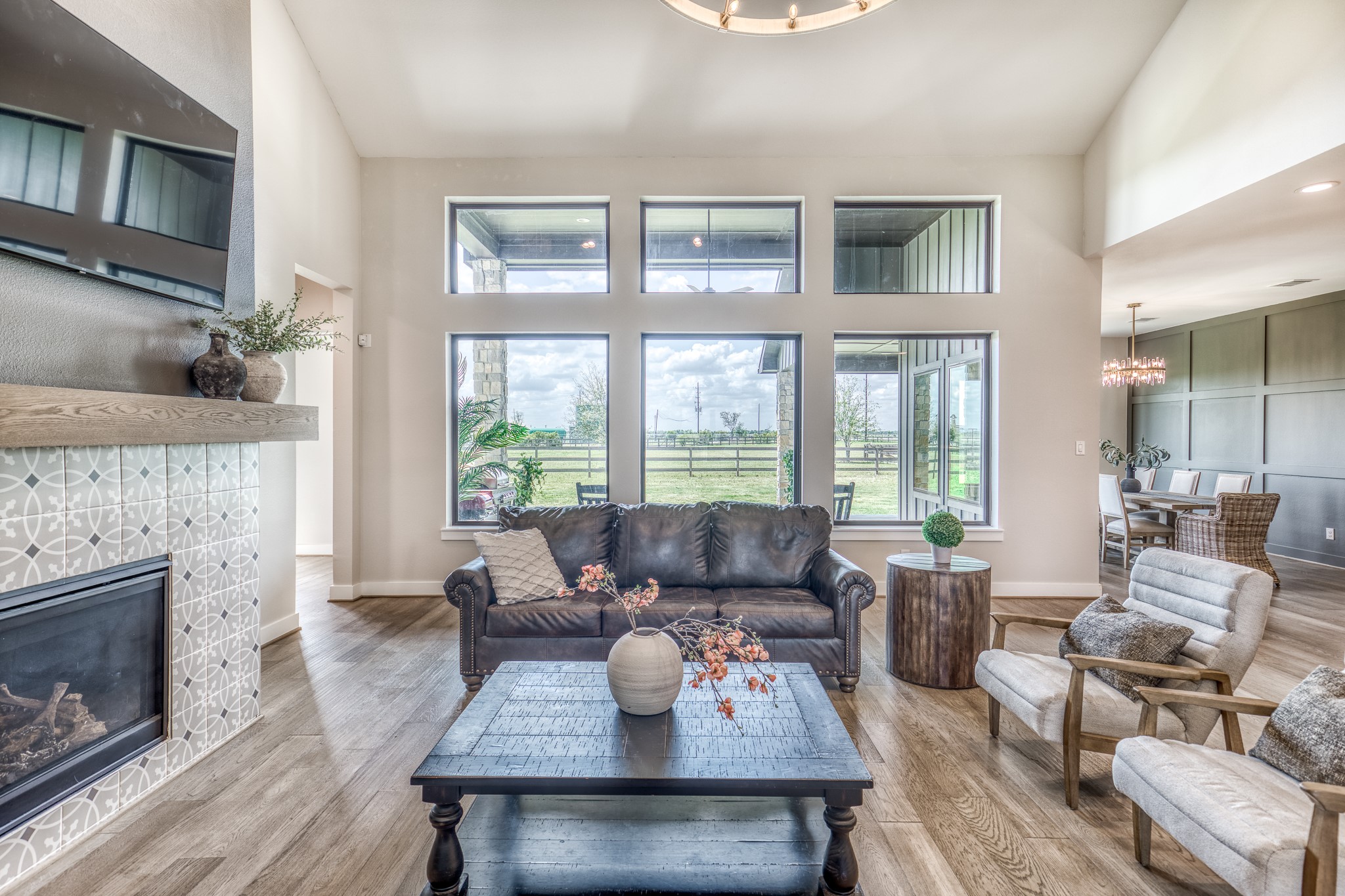 4009 Ranch Home Drive Waller, TX 77484 - Photo 14 of 49 a living room with furniture a fireplace and a floor to ceiling window