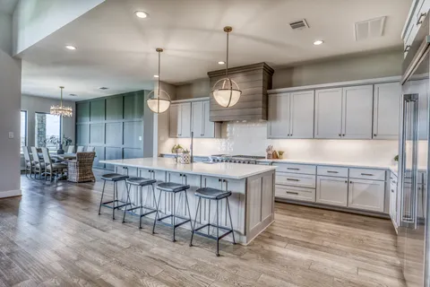 a kitchen with center island cabinets and wooden floor