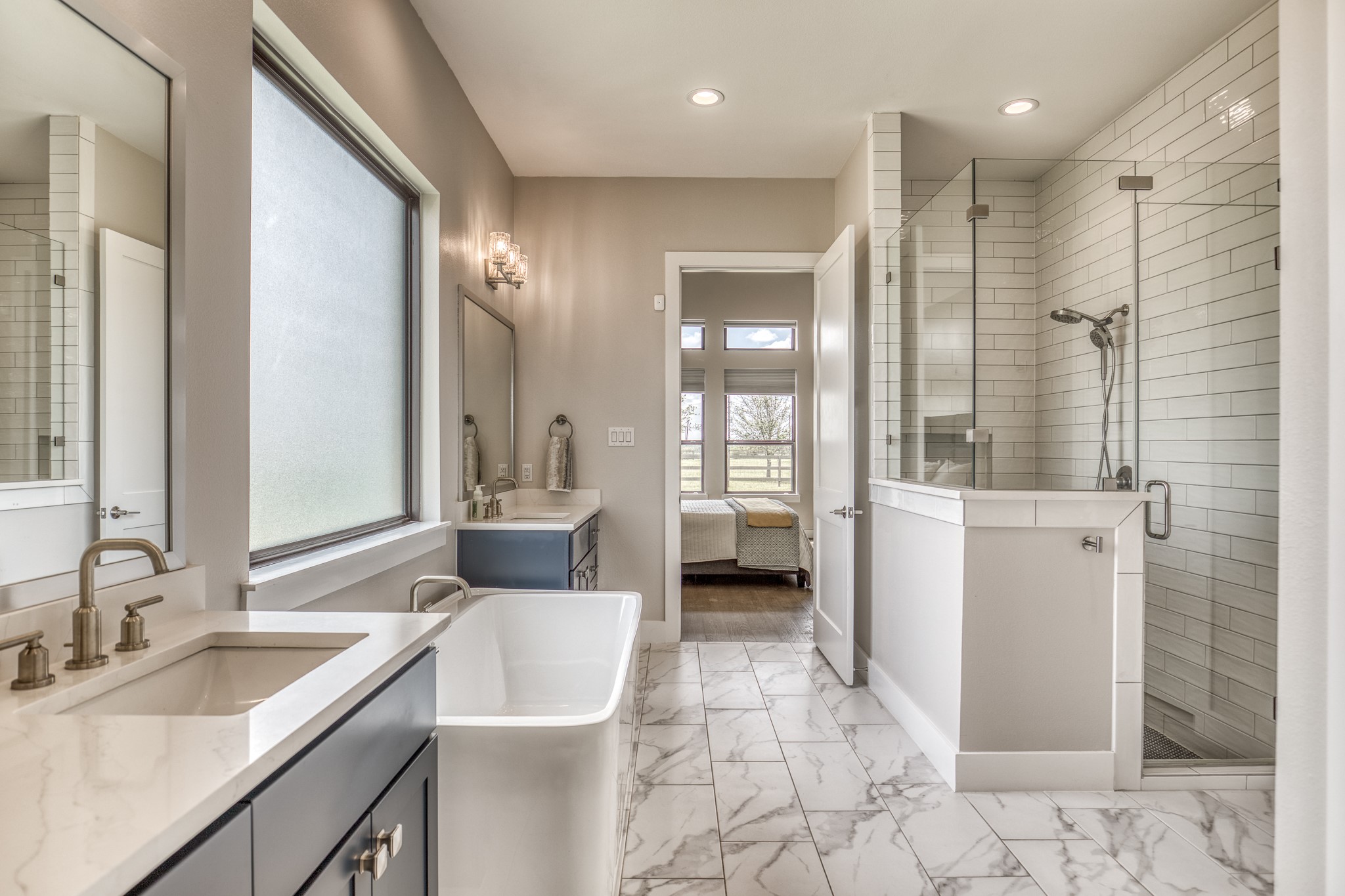 4009 Ranch Home Drive Waller, TX 77484 - Photo 26 of 49 a bathroom with a double vanity sink a mirror and a shower
