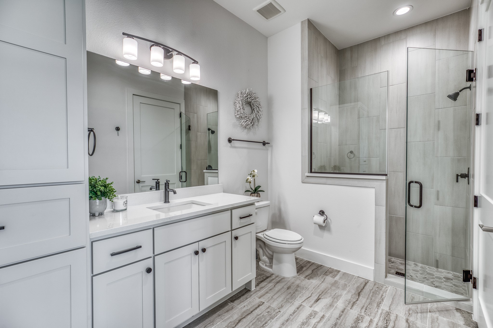 4009 Ranch Home Drive Waller, TX 77484 - Photo 30 of 49 a bathroom with a double vanity sink a toilet and shower