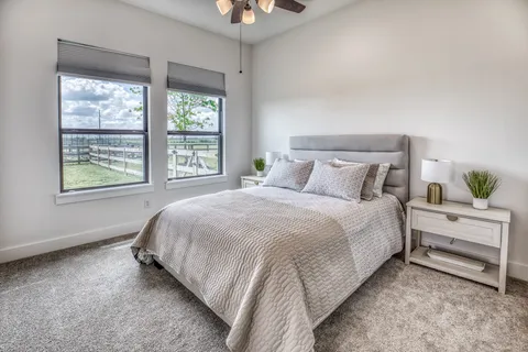a spacious bedroom with a bed and a window