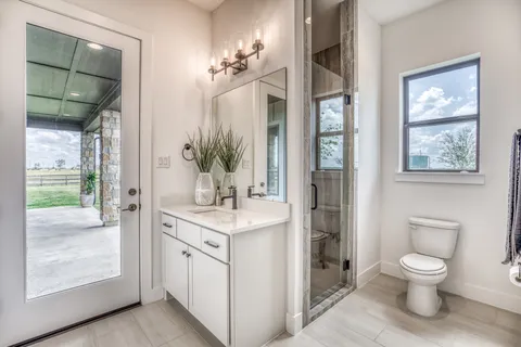 a spacious bathroom with a granite countertop sink toilet and shower