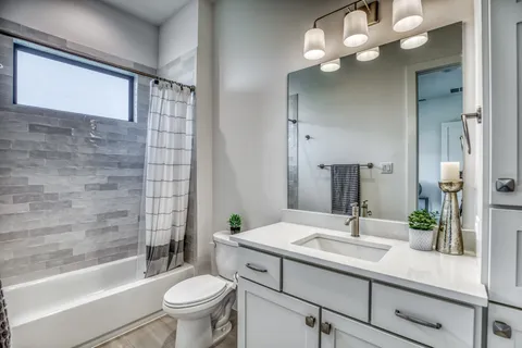 a bathroom with a sink a toilet and a mirror