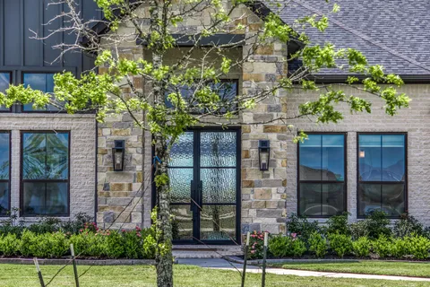 a front view of a building with a garden