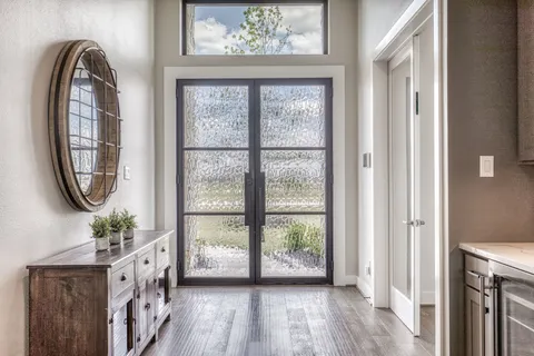 a view of an entryway with wooden floor