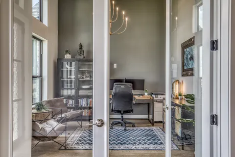 a view of workspace with wooden floor and windows