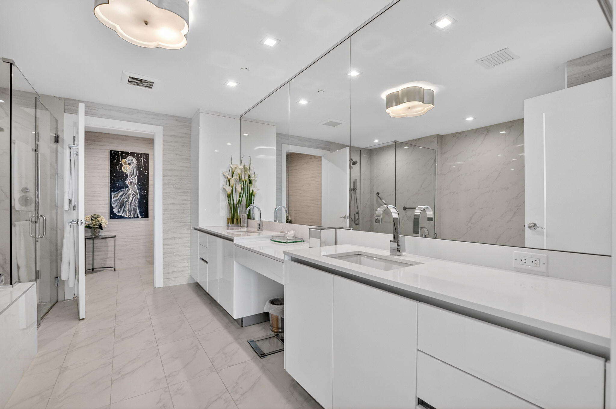 20155 Boca W Drive, Unit B701 Boca Raton, FL 33434 - Photo 23 of 78 a large bathroom with a large mirror vanity and shower