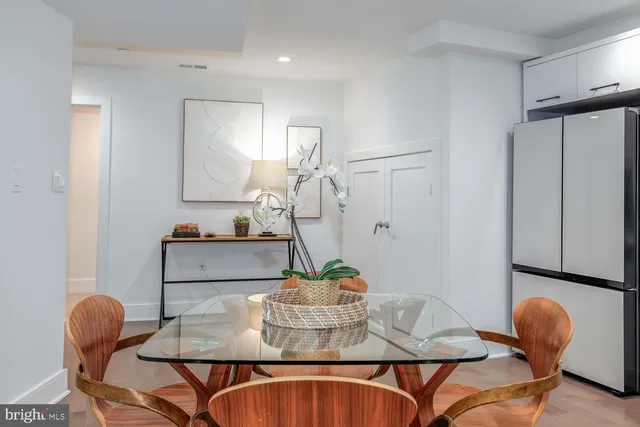 a dining room with furniture and wooden floor