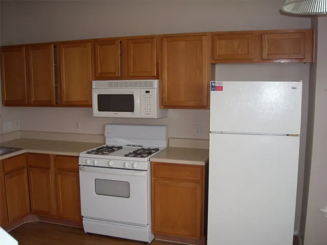 a kitchen with a refrigerator stove and microwave