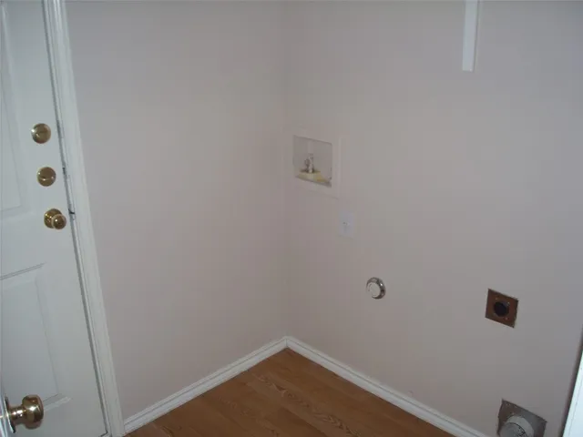 a view of a room with wooden floor