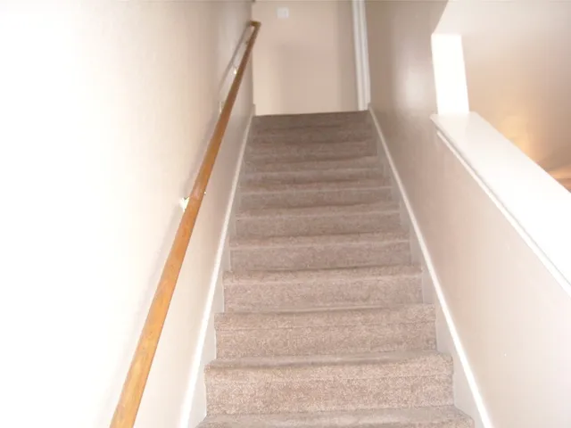 a view of staircase with white walls