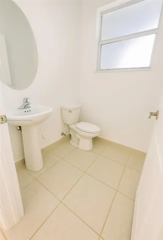 a bathroom with a toilet and a mirror