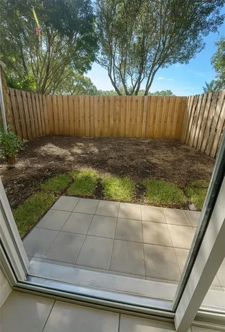 a view of backyard with wooden fence