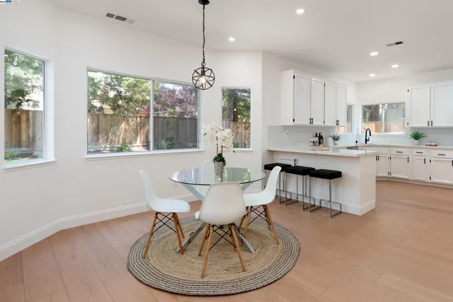 a living room with furniture a fireplace and a large window