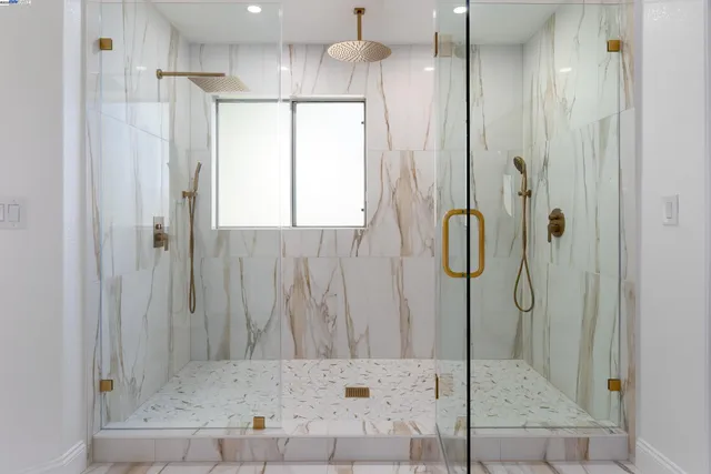 a bathroom with a double vanity sink mirror and bathtub
