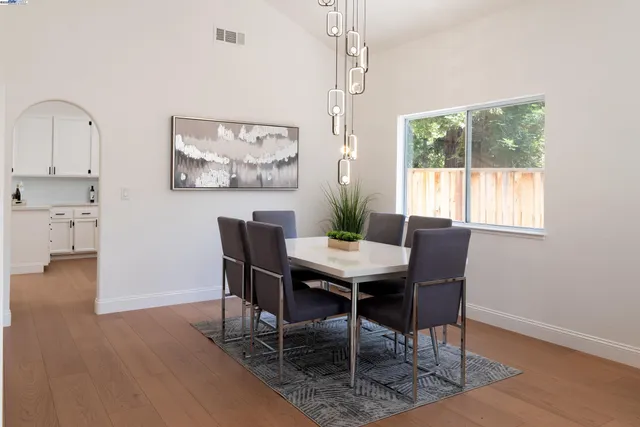 a view of a dining room with furniture window and wooden floor