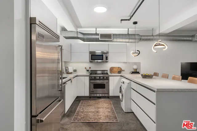 a kitchen with a stove and a refrigerator