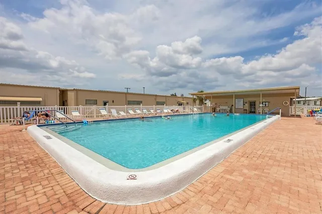 a view of a swimming pool with an outdoor seating
