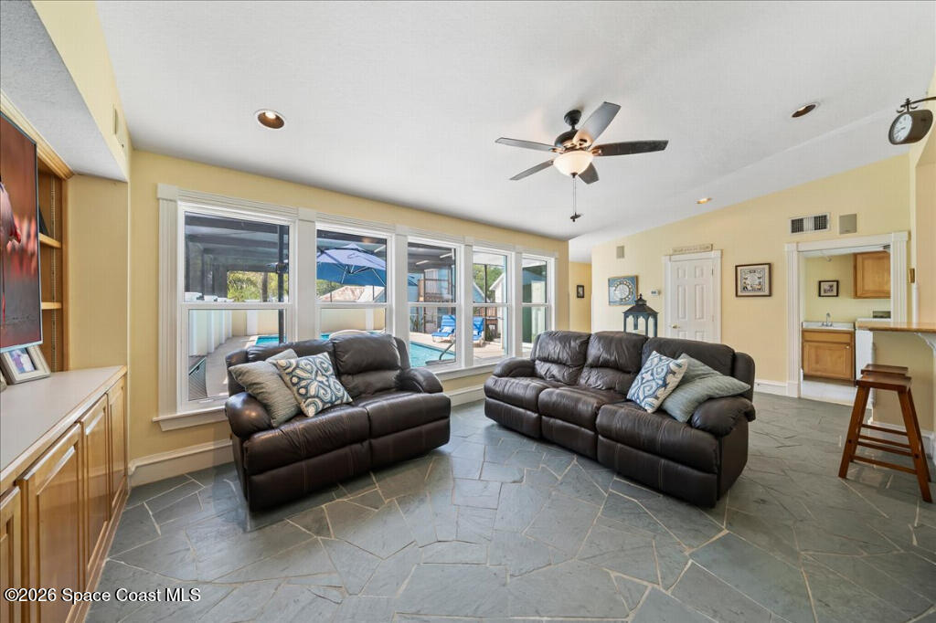 1110 Riverside Drive Titusville, FL 32780 - Photo 14 of 50 a living room with furniture ceiling fan and a window
