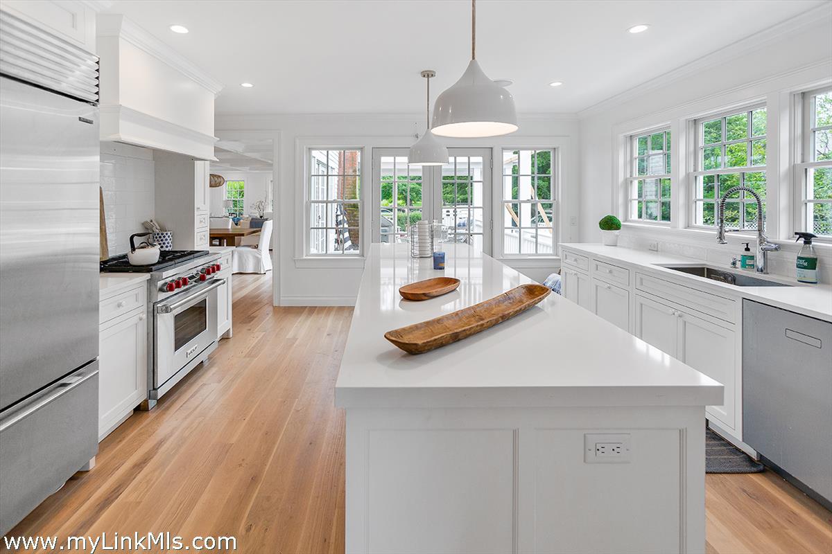 4 Cottle Lane Edgartown, MA 02539 - Photo 16 of 44 a kitchen with a sink stove and wooden floor