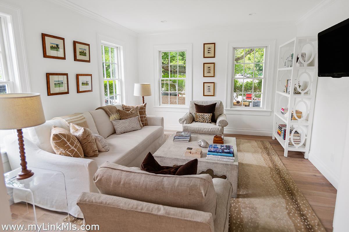 4 Cottle Lane Edgartown, MA 02539 - Photo 18 of 44 a living room with furniture a flat screen tv and a large window