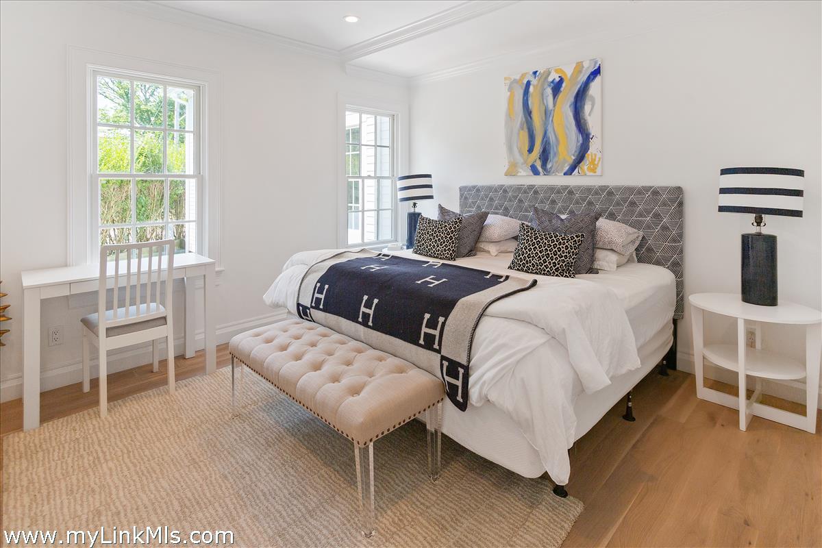 4 Cottle Lane Edgartown, MA 02539 - Photo 22 of 44 a bedroom with a bed and a table