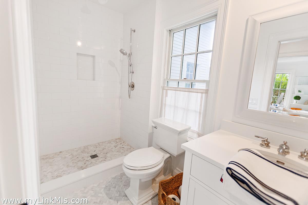 4 Cottle Lane Edgartown, MA 02539 - Photo 23 of 44 a bathroom with a sink a toilet and shower