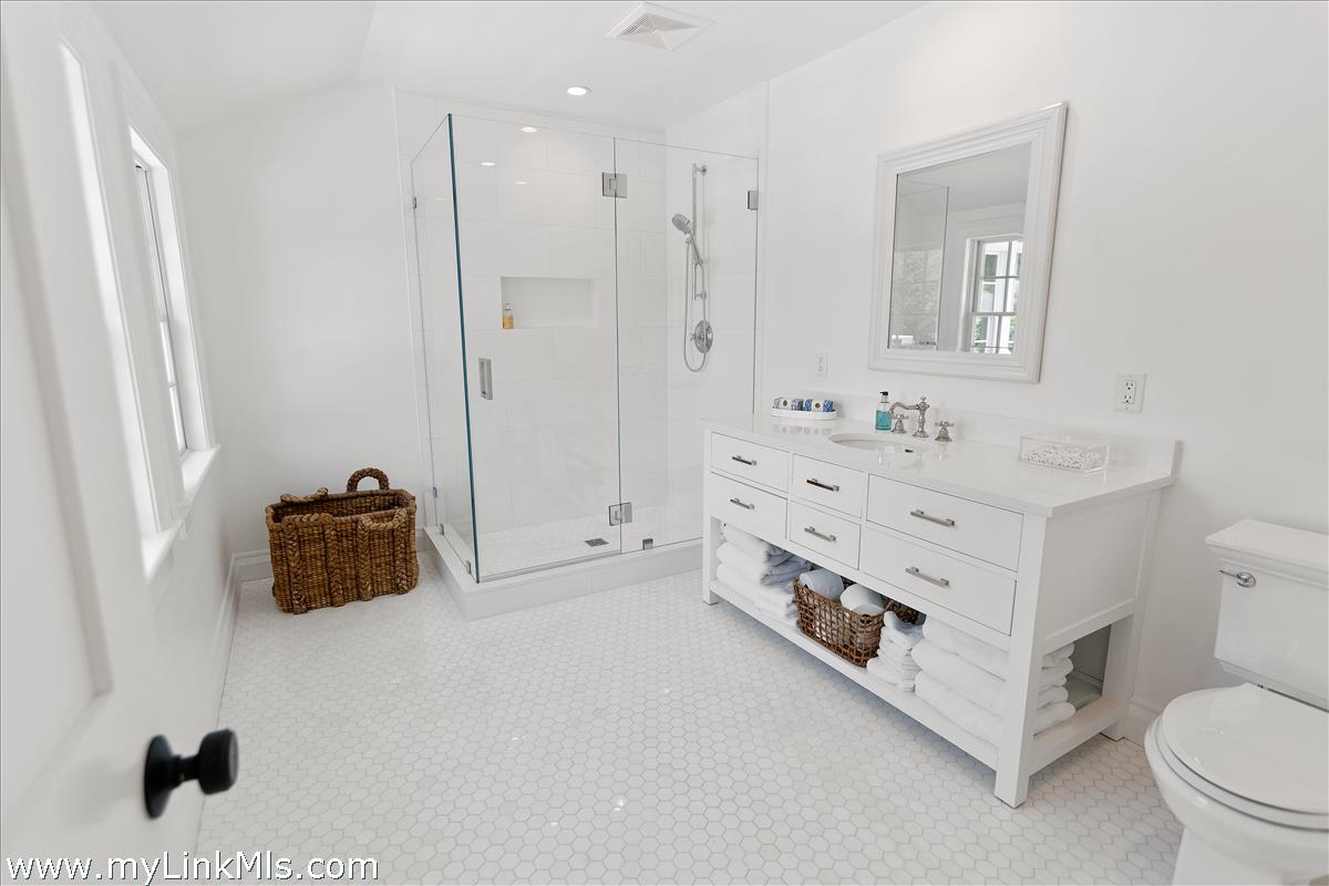 4 Cottle Lane Edgartown, MA 02539 - Photo 28 of 44 a bathroom with a double vanity sink and mirror