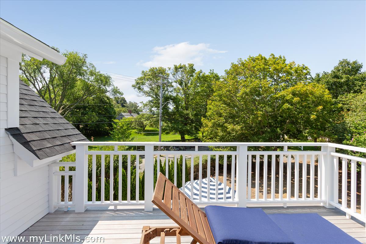 4 Cottle Lane Edgartown, MA 02539 - Photo 29 of 44 a view of a wooden deck and a backyard