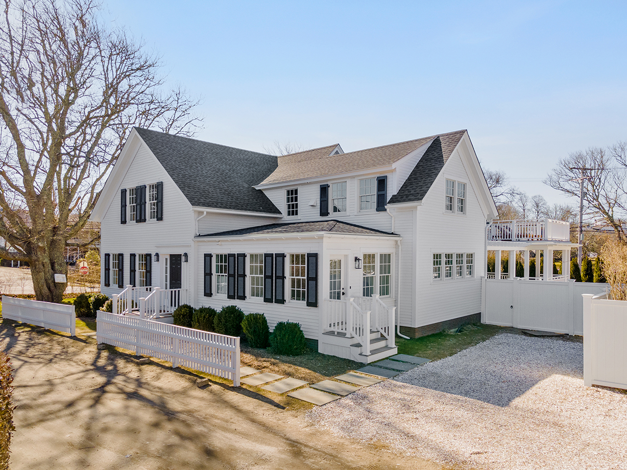 4 Cottle Lane Edgartown, MA 02539 - Photo 4 of 44 a view of a white house with a large windows next to a road