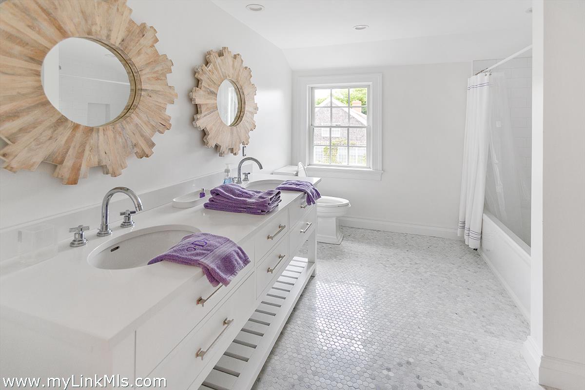 4 Cottle Lane Edgartown, MA 02539 - Photo 31 of 44 a bathroom with a double vanity sink and a mirror
