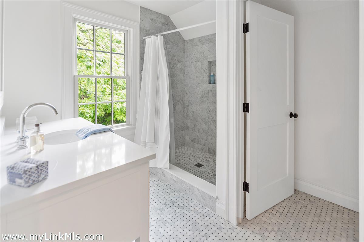 4 Cottle Lane Edgartown, MA 02539 - Photo 34 of 44 a bathroom with a granite countertop sink a mirror and shower