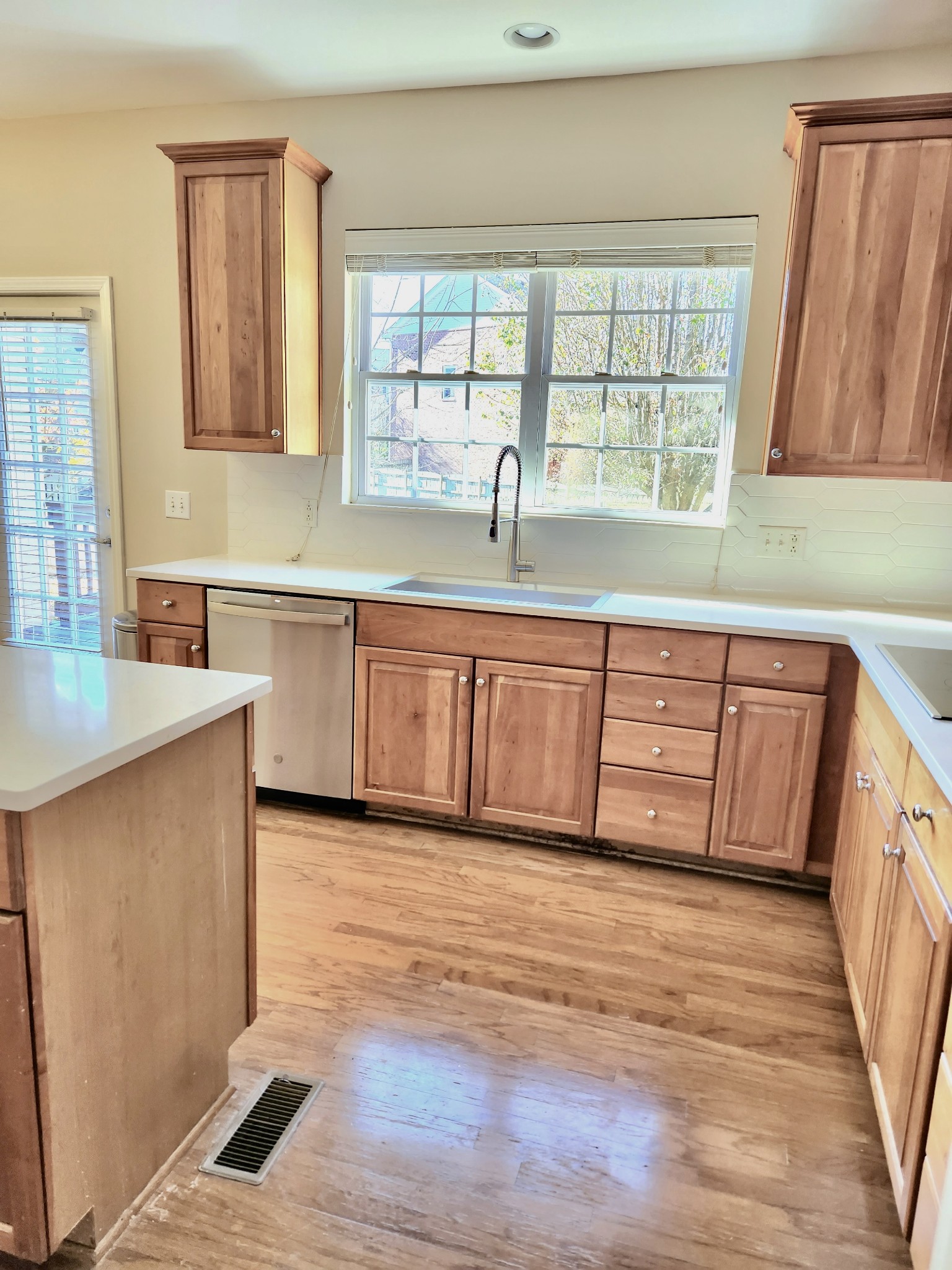 368 Logans Circle Franklin, TN 37067 - Photo 11 of 45 a large kitchen with granite countertop a large window a sink and white cabinets