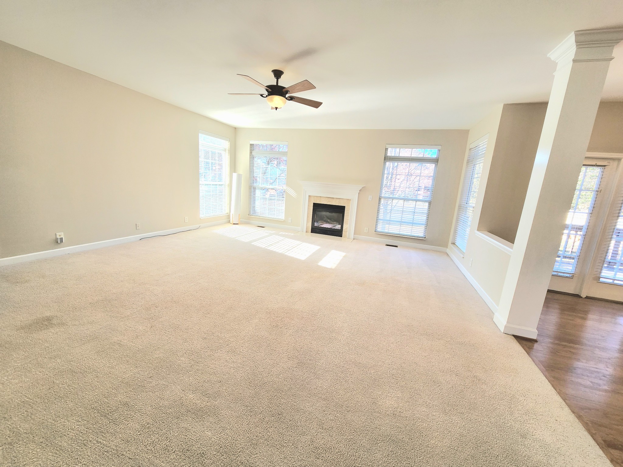 368 Logans Circle Franklin, TN 37067 - Photo 9 of 45 a view of an empty room with a fireplace and a window