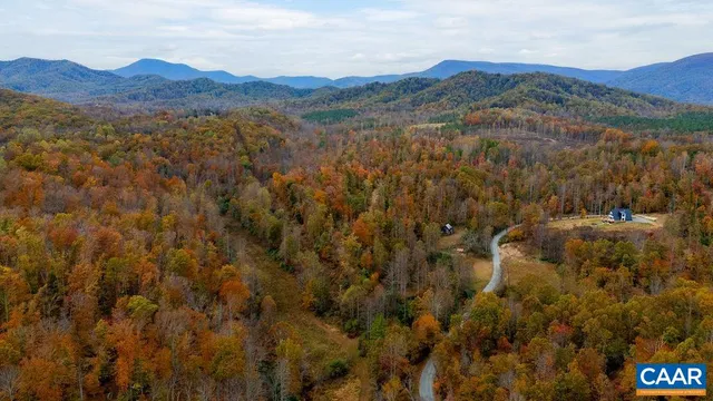 a view of a lush green hillside and houses