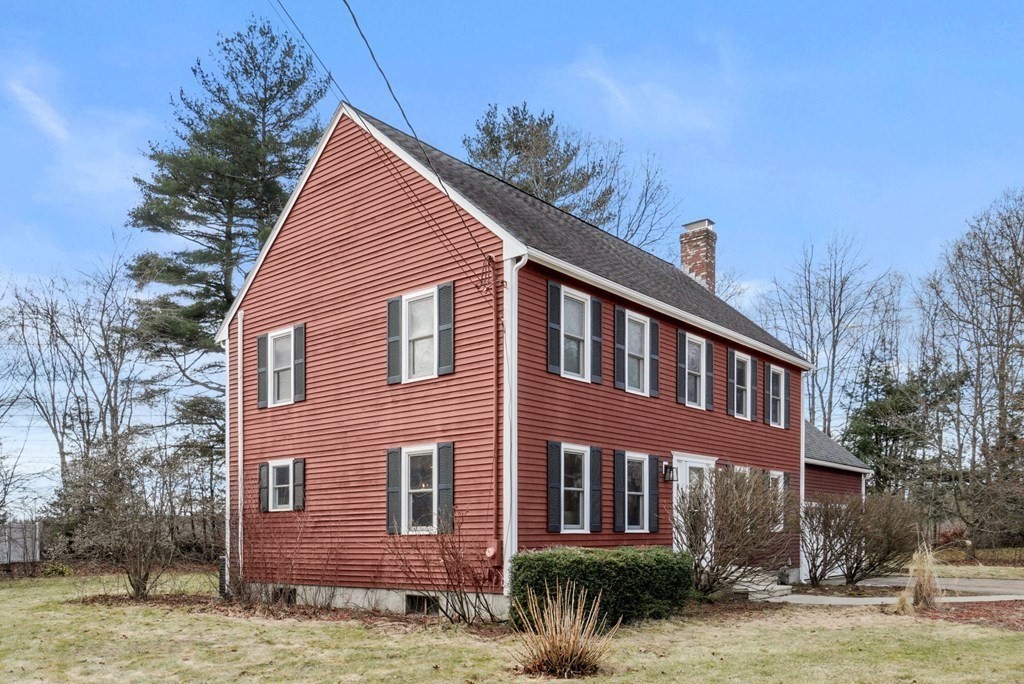 60 Hitching Post Drive Walpole, MA 02081 - Photo 2 of 37 a view of a brick house next to a yard with large trees