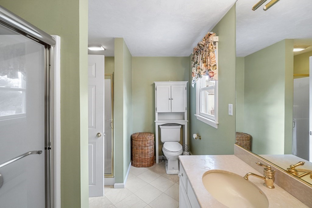 60 Hitching Post Drive Walpole, MA 02081 - Photo 23 of 37 a bathroom with a granite countertop sink and a mirror