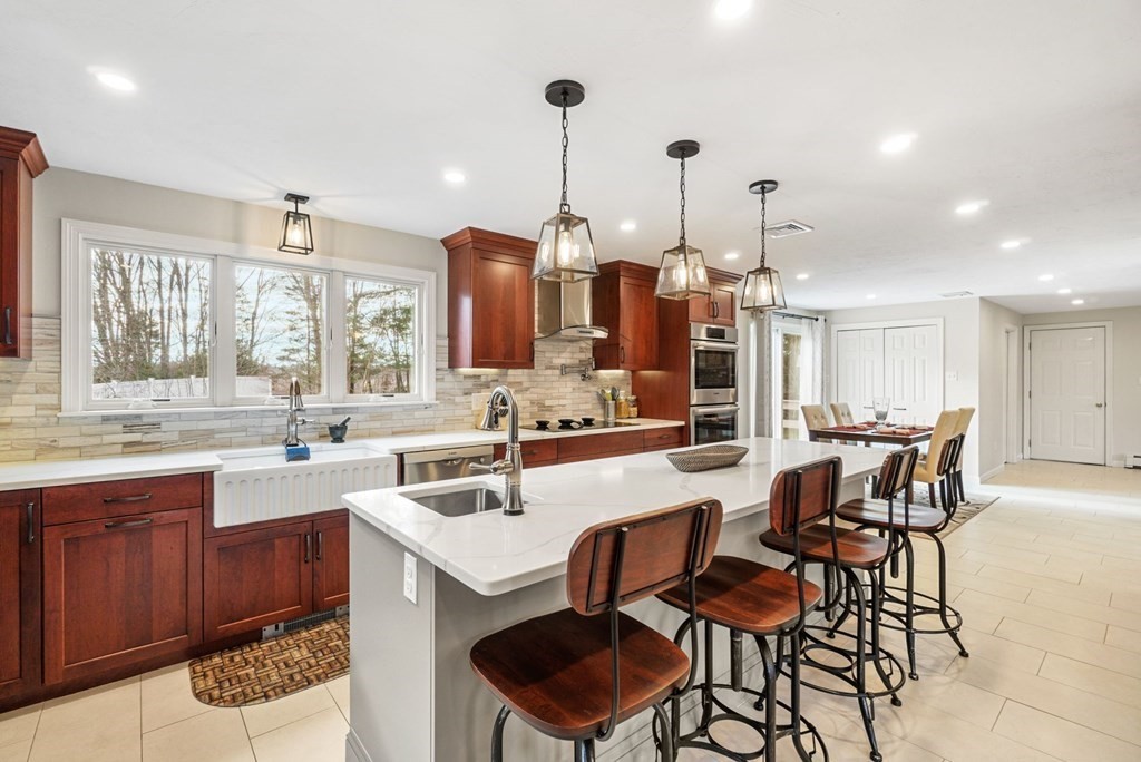 60 Hitching Post Drive Walpole, MA 02081 - Photo 8 of 37 a kitchen with a sink and chairs