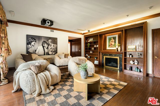 a living room with fireplace furniture and a wooden floor