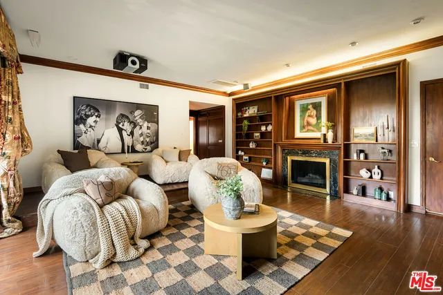 a living room with fireplace furniture and a wooden floor