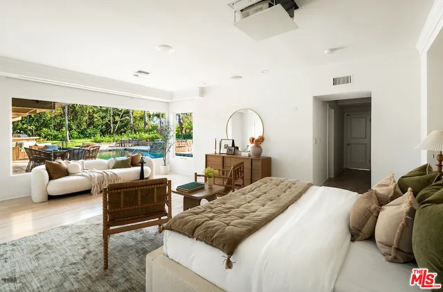 a bedroom with a bed and glass window