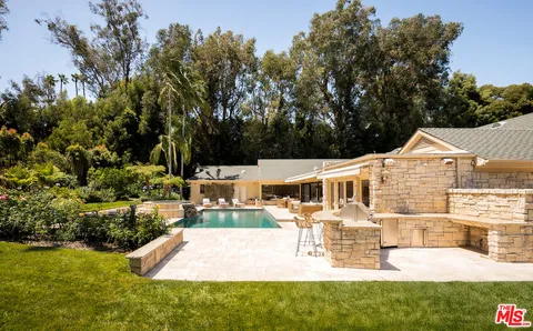 a view of a house with swimming pool and sitting area