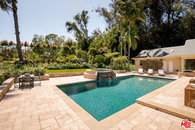 a view of a swimming pool with a patio