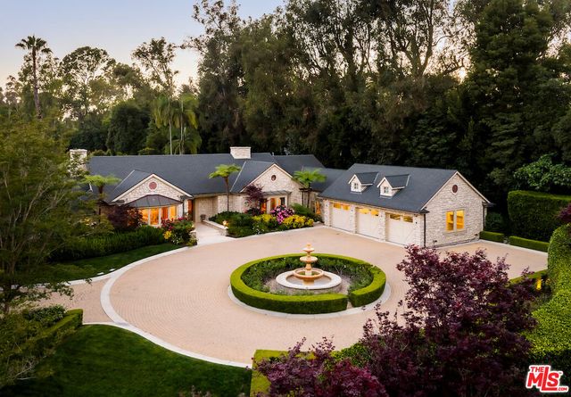 an aerial view of a house with garden space and lake view