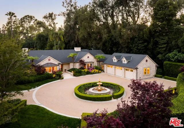 an aerial view of a house with garden space and lake view