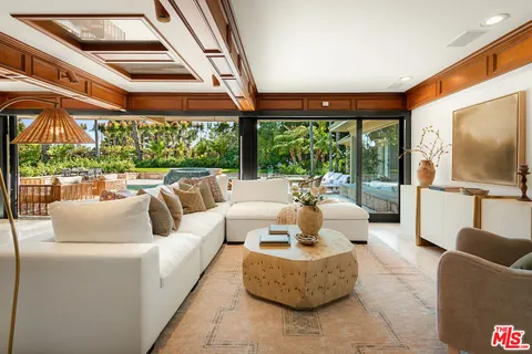 a balcony with furniture and large windows