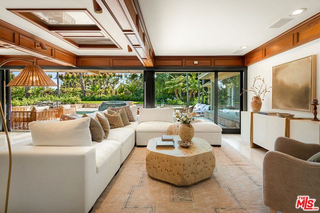 a balcony with furniture and large windows