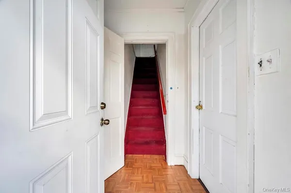 a view of a hallway with wooden floor and a hallway