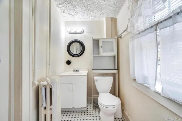 a bathroom with a toilet and a shower curtain