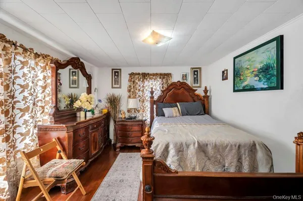 a bedroom with a bed mirror and window